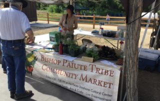 market stand at Bishop Paiute Community market selling fresh produce